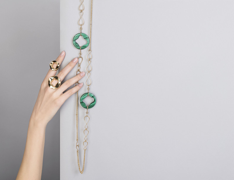 golden rings and golden and green long neclace