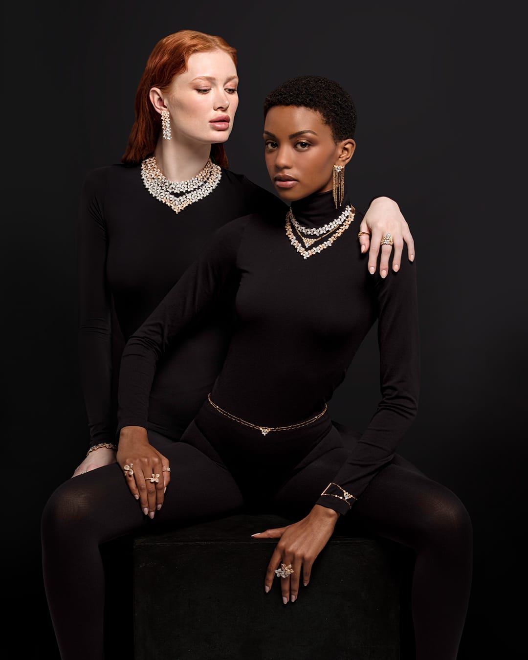 two models wearing precious necklaces and earrings