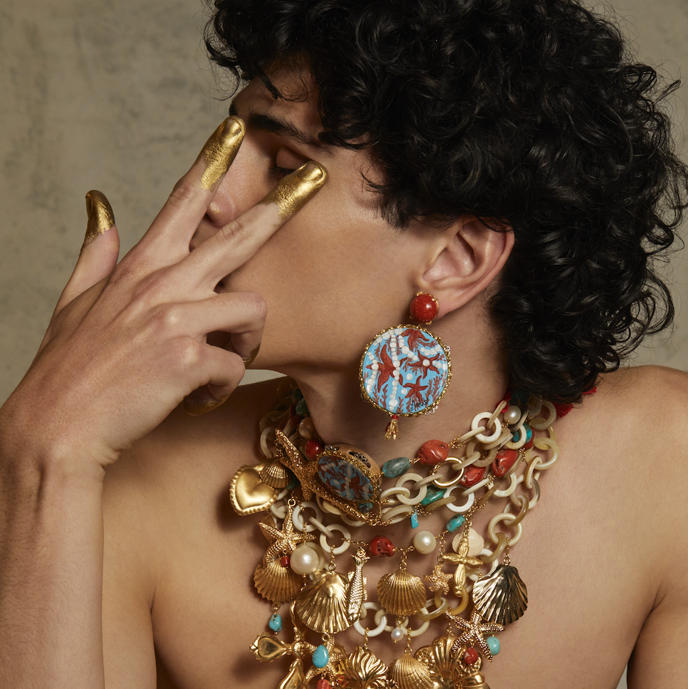 gold and precious materials multicolored jewelries worn by a model