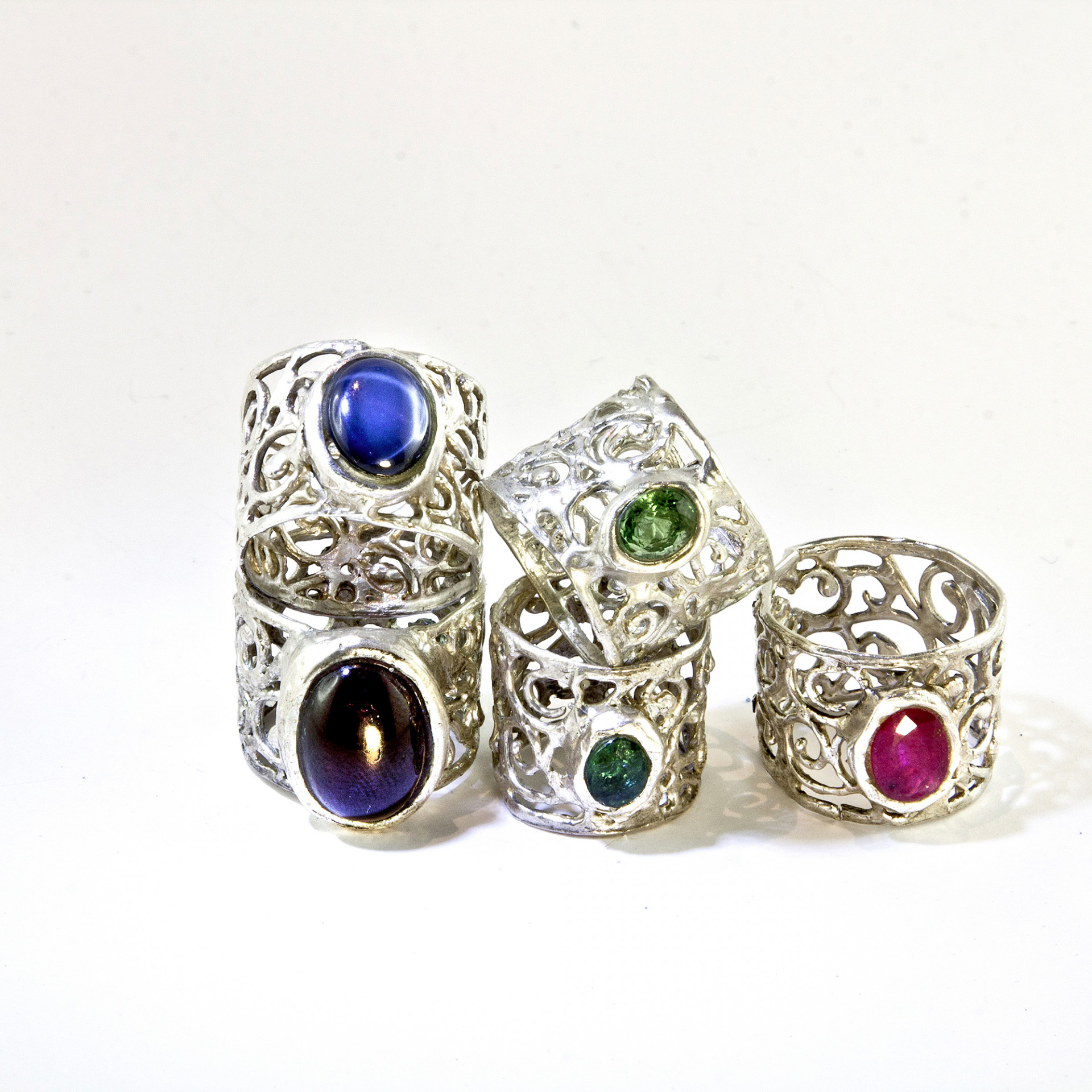 set of silver rings with colorful precious stones