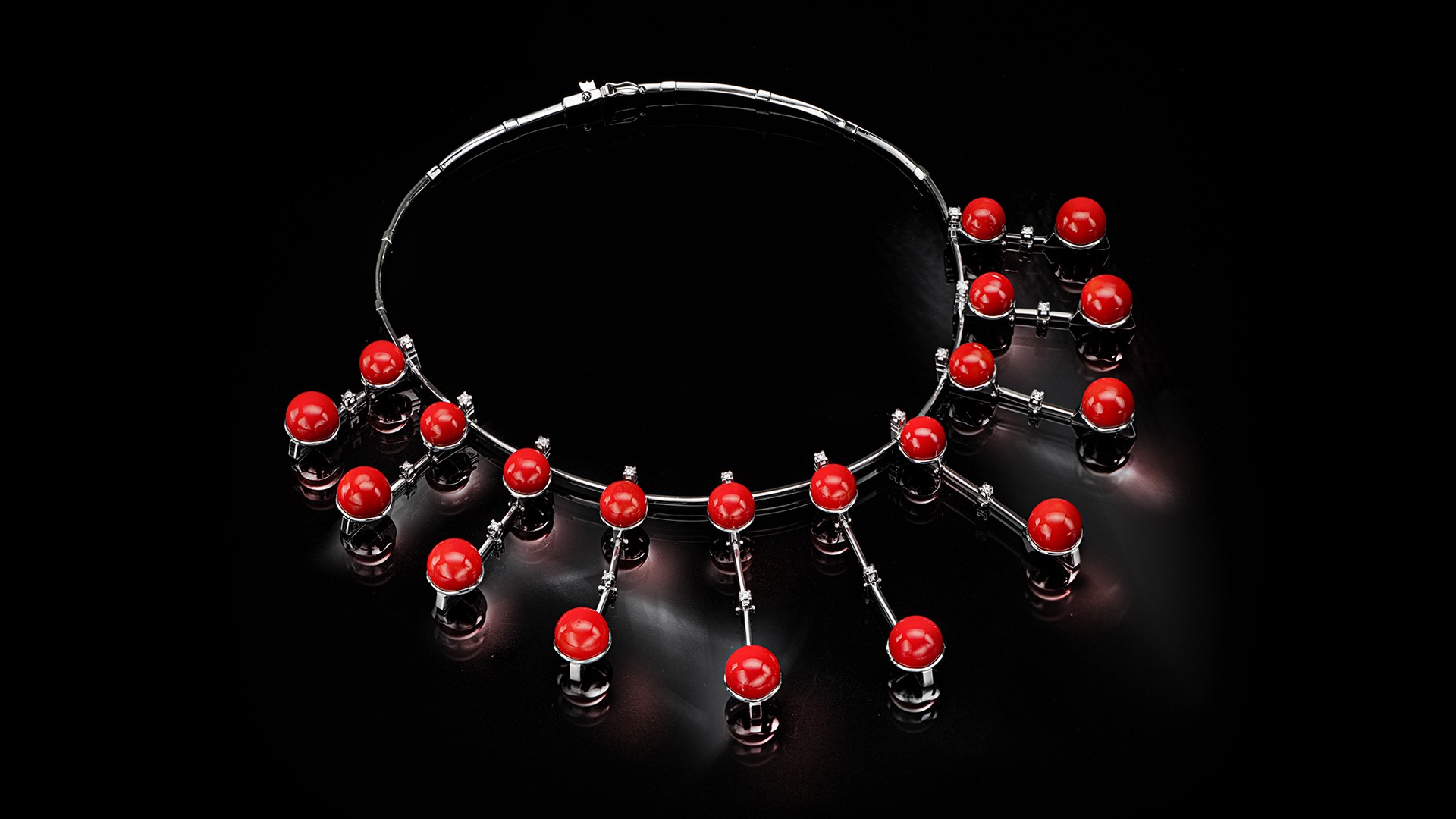 silver necklace with red pendants and precious stones