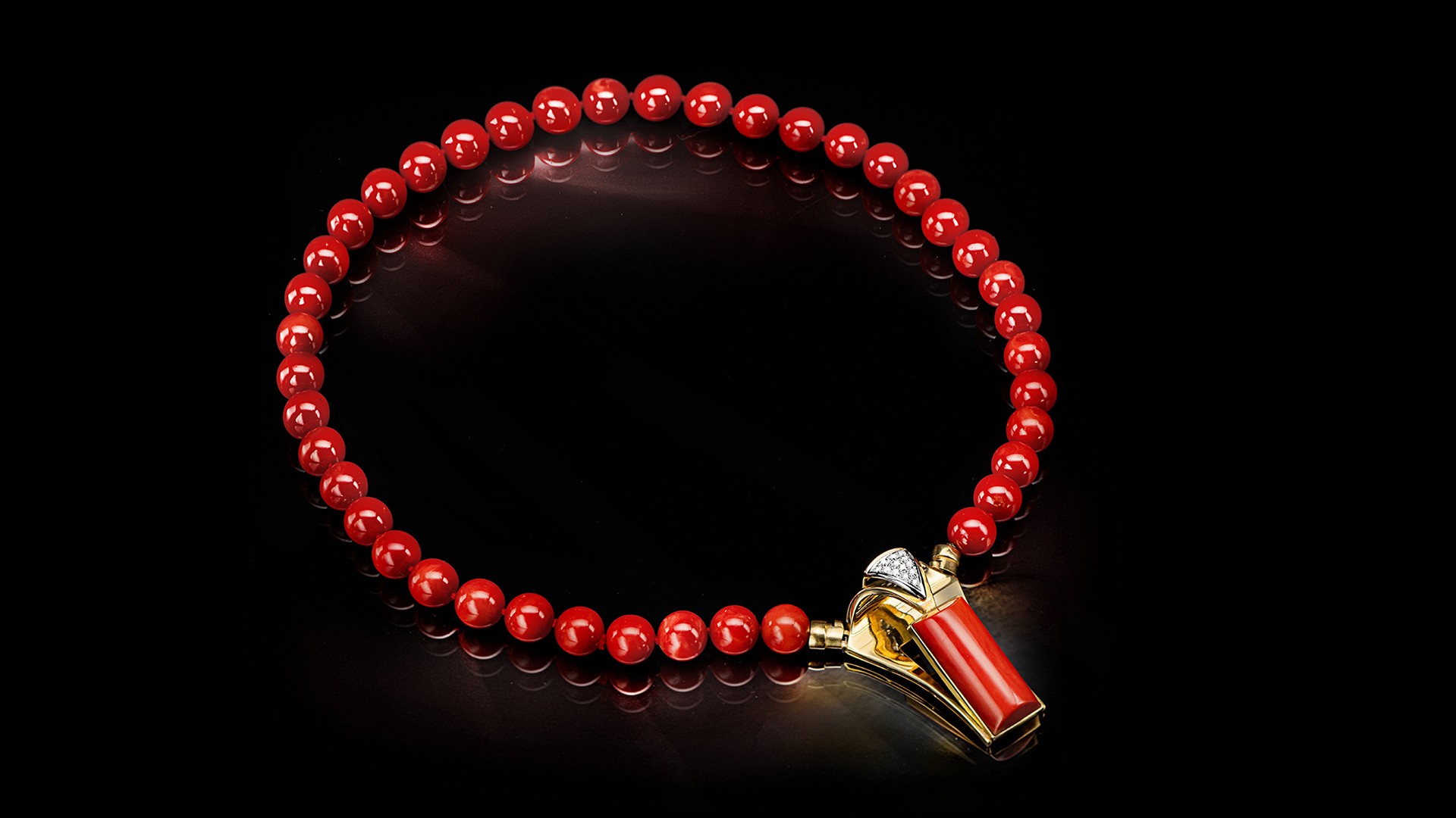 red coral necklace with precious stones and golden details