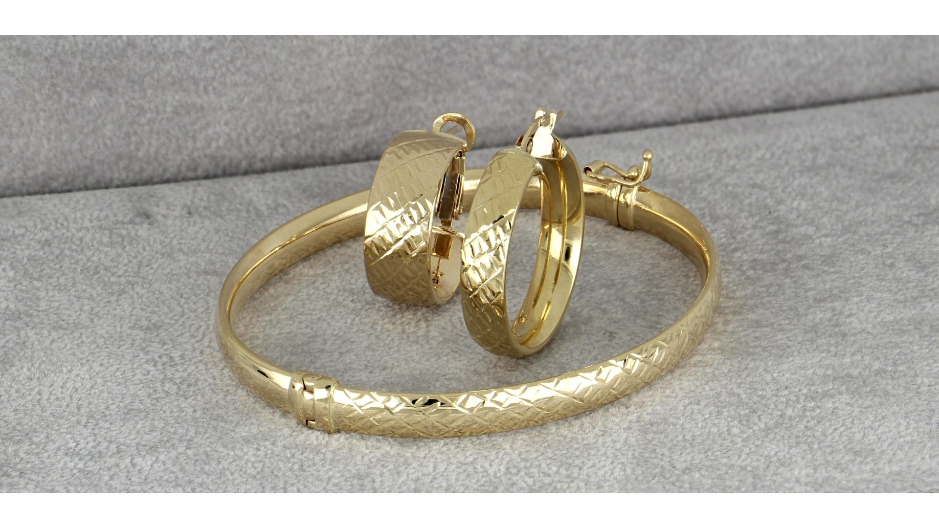 set of gold bracelet and earrings