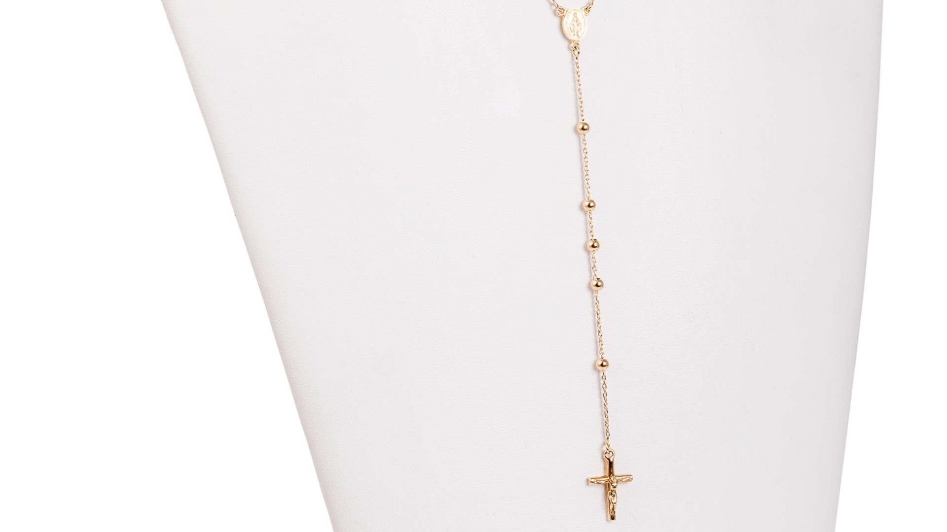 gold pendant with a religious cross pendant