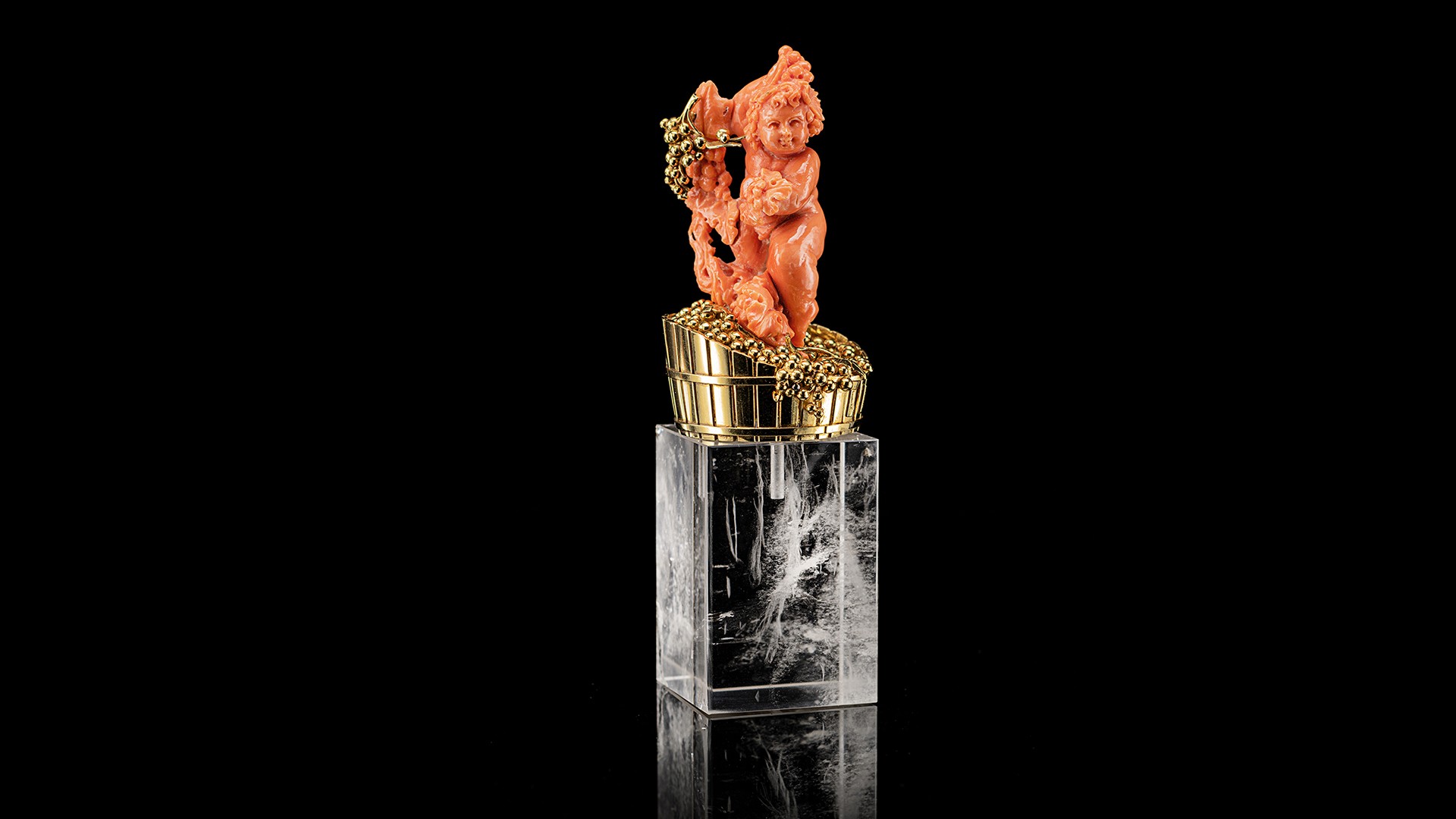 red coral statuette with golden details