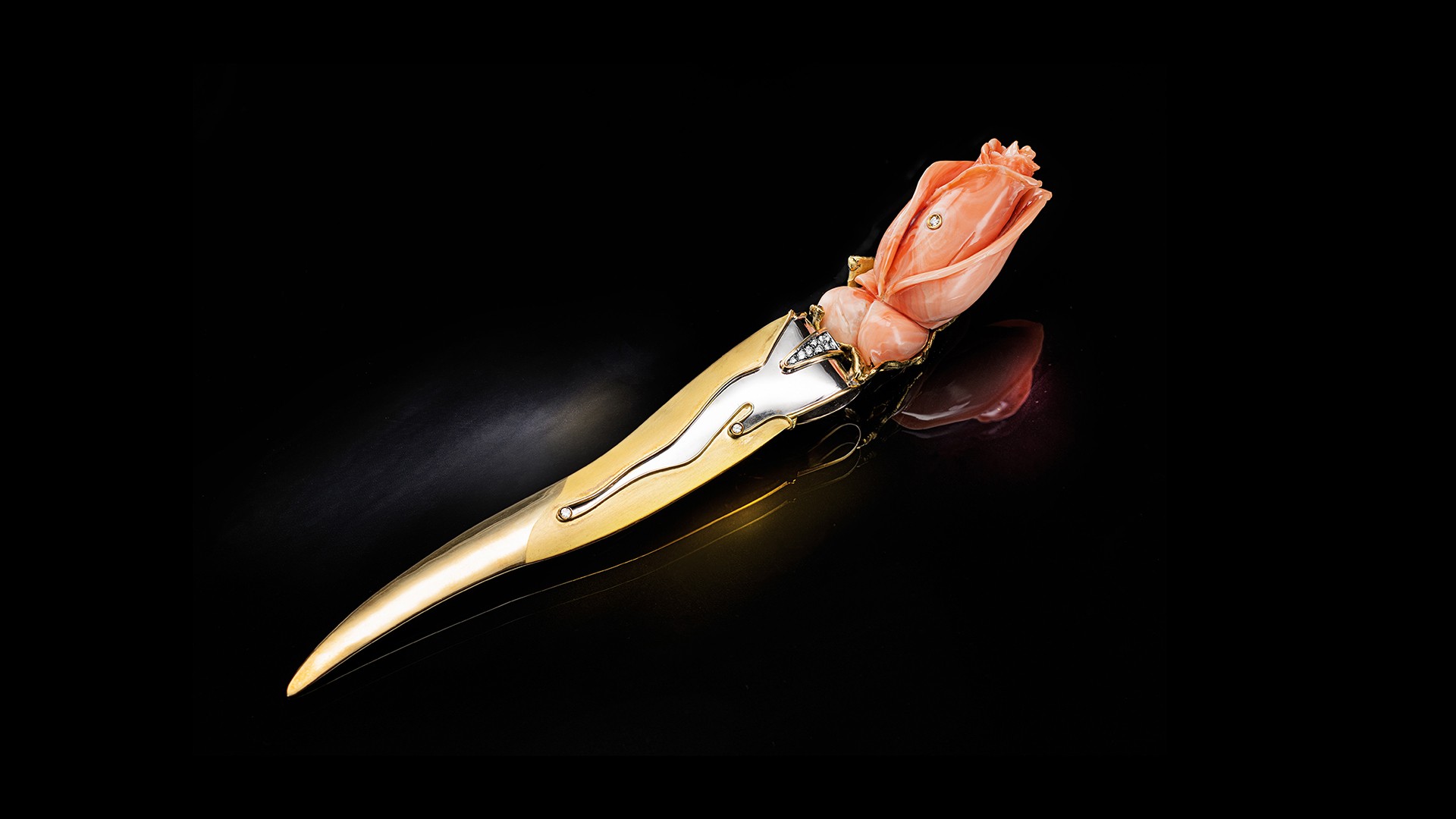 golden paper knife with precious stones and pink rose