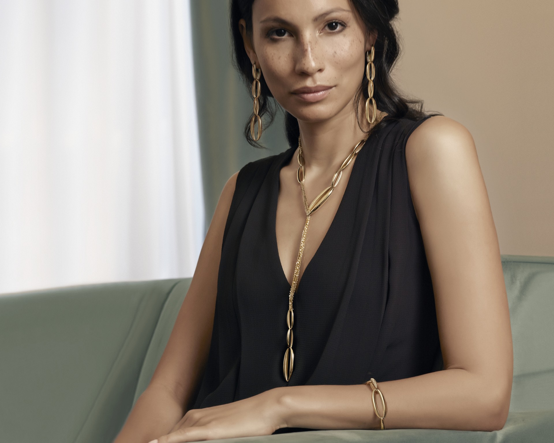 model with set of earrings, necklace and bracelet