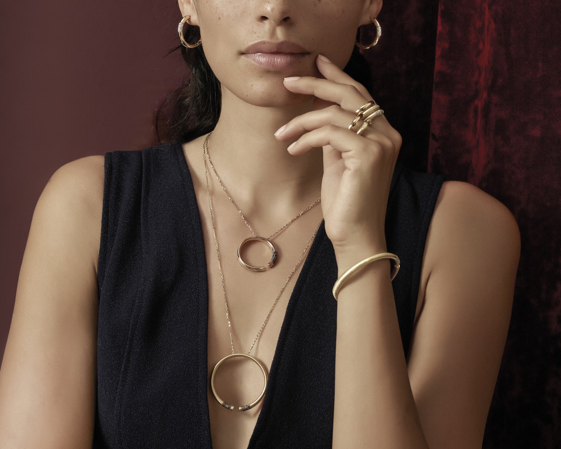 model with set of earrings, necklace, bracelet and rings